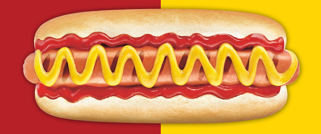 Image of a hot dog covered with ketchup & mustard